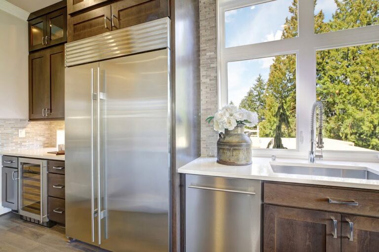 Built-in Sub-Zero refrigerator in a luxury kitchen with custom cabinetry and stainless steel finish