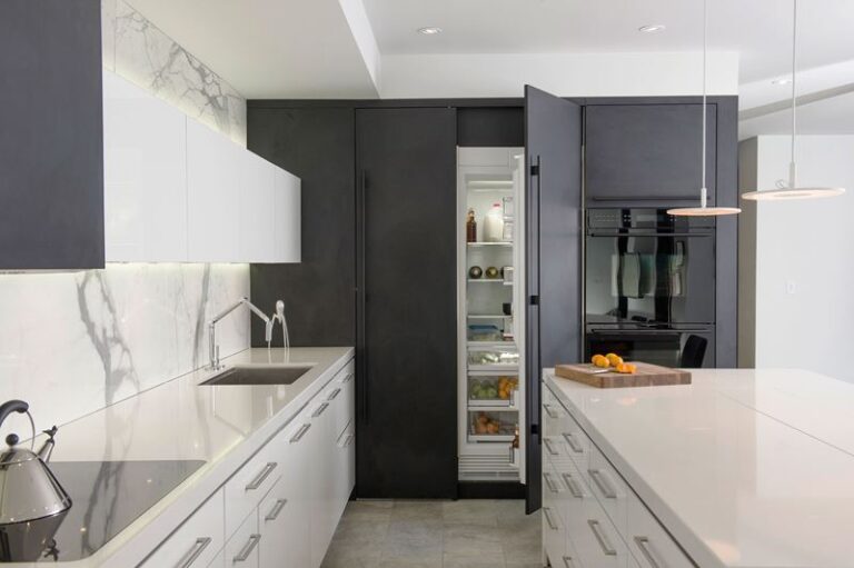 Built-in Sub-Zero refrigerator installed flush with custom kitchen cabinetry in a modern kitchen