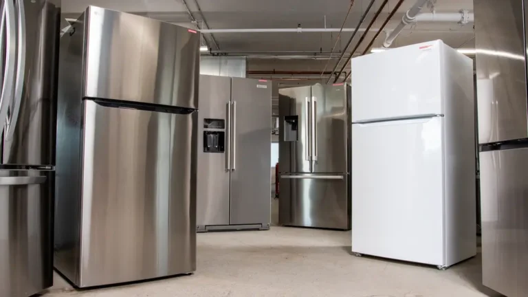 Selection of refrigerators from different brands displayed in an appliance showroom