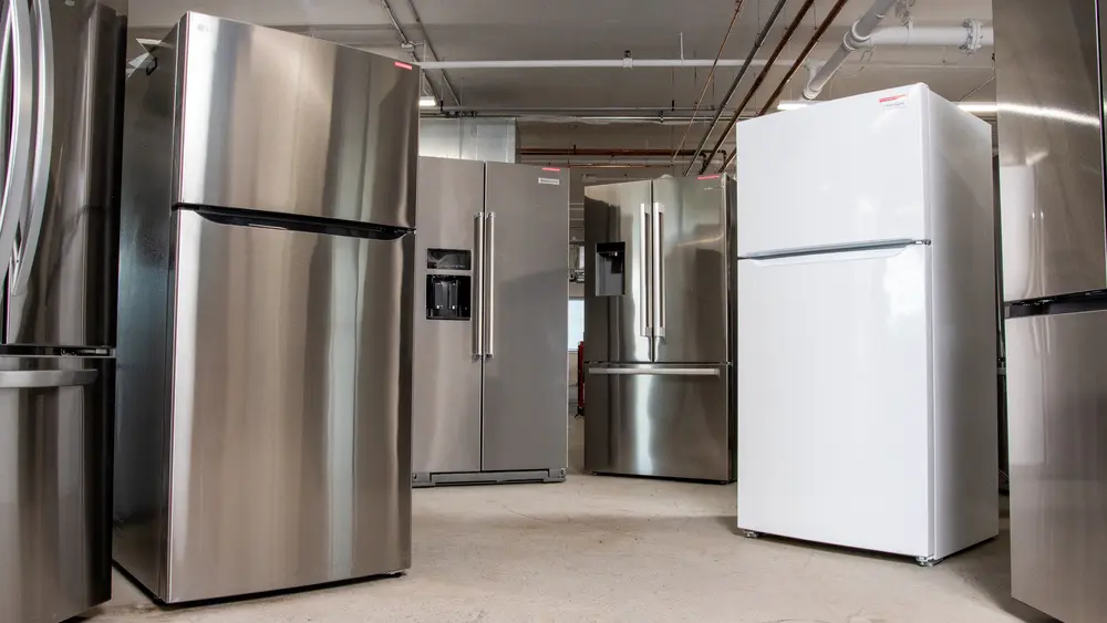 Selection of refrigerators from different brands displayed in an appliance showroom