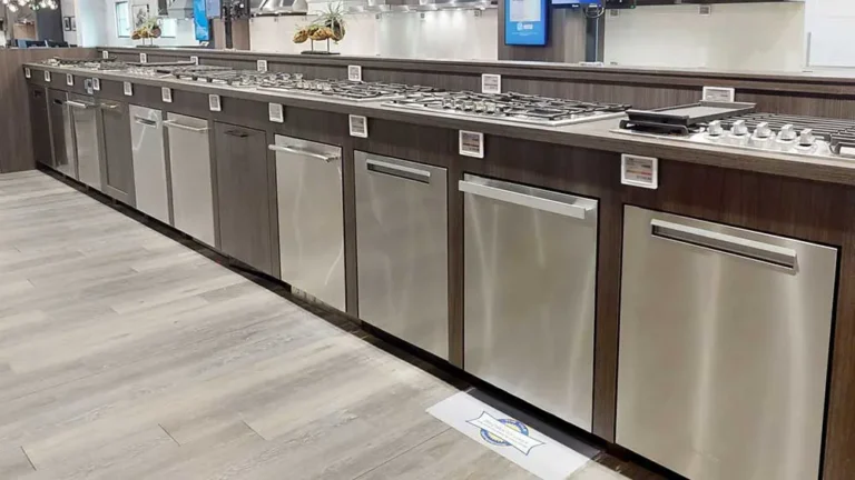 Selection of built-in dishwashers from different brands displayed in an appliance showroom