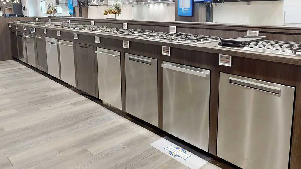 Selection of built-in dishwashers from different brands displayed in an appliance showroom