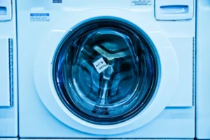Front-load washing machine with an out-of-service note inside the door